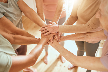 Image showing Senior woman, hands together and teamwork in gym for support, collaboration and fitness friends or people. Group hand, exercise team and elderly women with goal, target and success with community