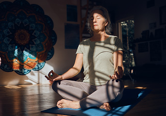 Image showing Yoga, prayer hands and meditation of senior woman in dark house for spiritual wellness alone. Chakra energy, zen or mature female training in home to relax with eyes closed for mindfulness or peace.