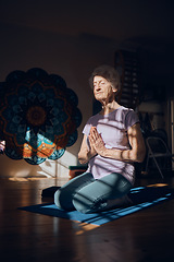 Image showing Meditation, zen and elderly woman doing yoga in dark room, shadow and positive energy, balance and mindfulness. Wellness, spiritual and stress relief, calm and peace of mind with fitness and exercise
