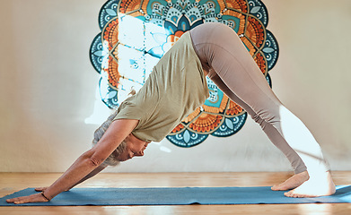 Image showing Yoga, fitness and workout with a senior woman training in a studio for wellness or mental health. Exercise, holistic and stretching with a mature female yogi in a health class for active seniors