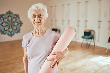 Image showing Yoga, mat and portrait of a senior woman in a wellness studio for an exercise or meditation class. Happy, smile and elderly female in retirement at mind and body pilates workout for peace and balance