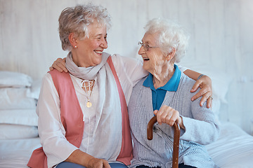 Image showing Senior woman, friends and embrace on bed in house, apartment or nursing home with happiness. Elderly women, hug and smile together in bedroom for care, bonding and best friend love in retirement