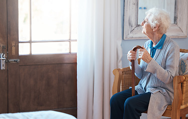 Image showing Thinking, sad and senior woman thinking of life with a walking stick by the window in the room in a retirement house. Elderly female with depression, disability and retirement idea in a nursing home