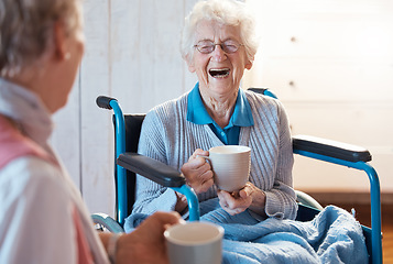 Image showing Senior woman, friend and coffee or tea while in a wheelchair for a disability or rehabilitation and happy or laughing about funny conversation or joke. Old people together for fun in nursing home