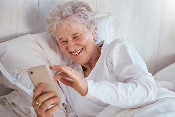 Image showing Happy elderly woman, bed or phone on social media for meme, comic or joke on internet. Senior lady, bedroom or smartphone tech with laugh at social network, funny video or email on web, app or online