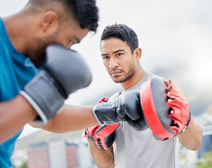 Image showing Fitness, personal trainer and boxing exercise for sports competition, training or self defense practice in the city. Boxer doing intense power workout with coach in preparation for competitive fight