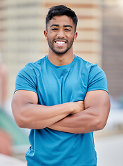 Image showing Fitness, exercise and portrait of a sports man standing arms crossed outdoor with a smile on his face. Workout, health and happy with a male athlete training outside for cardio or strong muscles