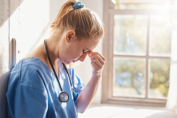 Image showing Headache, stress and burnout of woman doctor, sad worker and medical employee. Frustrated, depression and tired nurse in hospital, mental health challenge and anxiety, pain and emotion of bad news