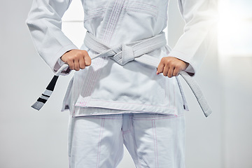 Image showing karate belt, martial arts and woman ready for fight battle, white dojo training or fitness challenge workout. Warrior motivation, taekwondo and hands of girl learning self defense for safety security