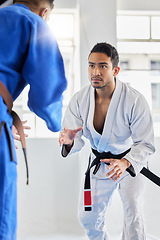 Image showing Men, martial arts and karate training in dojo to practice fighting skill. Taekwondo, fitness or self defense class for workout, battle exercise or sports challenge of people in match or competition.