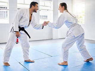 Image showing Fist bump, support and couple in karate, training and teaching in partnership for motivation in self defense. Goal, fight and man and woman with unity in taekwondo for exercise and fitness at a club