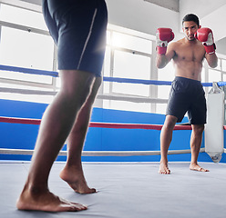 Image showing Boxing, sports and fight with a man athlete in the ring with a rival for competition in a sport club. Gym, fitness and exercise with a male fighter and coach training in a health facility together