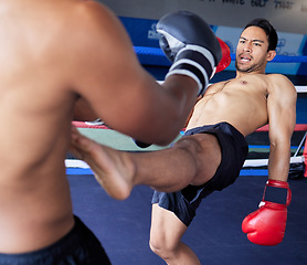 Image showing Boxer, fight and sports competition with men in boxing ring for exercise, workout and martial arts workout at a fitness club. Athlete man in action with a kick for combat sport at a gym for health