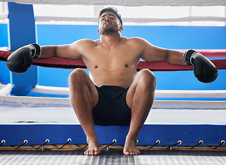 Image showing Tired, lose and boxer sad about a fight, boxing fail and burnout in a ring at a club. Depression, stress and man depressed about defeat during training, stress from sports and mental health problem