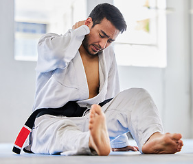 Image showing Karate, sports injury and neck pain of man at fitness club for martial arts, exercise and training to fight for competition. Athlete male tired after taekwondo, sport and training with health problem