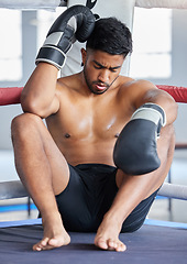 Image showing Mma, boxer and man sad, loss and defeat in ring from sports boxing match at the gym or arena. Angry male athlete in fight club, fatigue and depression from fighting sport workout or training exercise