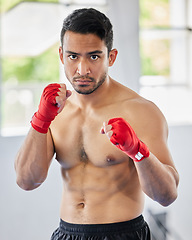 Image showing Fight, fist and kickboxing athlete man looking serious, angry and ready for martial arts exercise, training and competition. Asian sports or Muay thai model portrait for train session at ftness gym