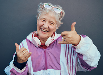 Image showing Shaka sign, portrait and senior woman in retirement standing by gray wall with a smile or happiness. Happy, fun and friendly elderly lady pensioner in the outdoor city with a hang loose hand gesture.