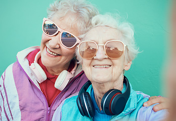 Image showing Senior women, fashion and retro selfie friends with sunglasses, headphones and vintage clothes in retirement. Portrait of cool old people together for pop art and hug profile picture against wall