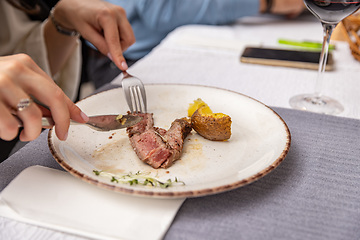 Image showing Grilled sliced steak with baked potatoes