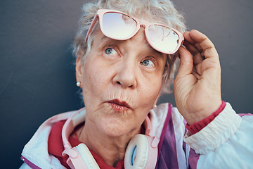 Image showing Fashion, trendy and senior woman in city standing by grey wall with stylish, urban and cool outfit. Pensioner, freedom and fashionable elderly female in retirement with modern clothes in town street.