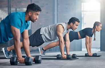 Image showing Fitness, teamwork and group with weights, focus and training for a body goal together in the gym. Exercise, power and strong friends in a kettlebell class for a strength training workout at a club