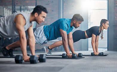 Image showing Group, workout and dumbbell push up at gym for muscle, power or strength. Teamwork, sports or energy of people, athletes or bodybuilder friends exercise or training at fitness center for healthcare.