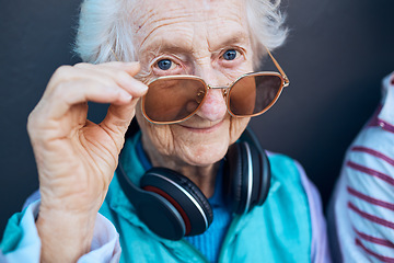 Image showing Glasses, cool and fashion portrait of old woman with music headphones, luxury senior style or creative accessory. Vision, wellness and face of elderly retirement person with designer brand sunglasses