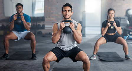 Image showing Fitness, workout and kettlebell with a personal trainer in class with a group of students for exercise. Portrait, gym and strong with a coach weight training a man and woman athlete in a sports club