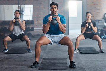 Image showing Fitness, kettlebell and personal trainer with a man coach training a class in the gym for health. Exercise, workout and bodybuilder with a male athlete teaching students in a club for strong muscles