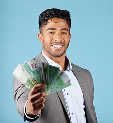 Image showing Businessman, money and rich with cash, income and happy with profit, salary and finance currency in blue mockup studio background. Investment, male employee or working in economy or financial growth