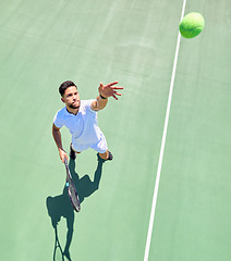 Image showing Top view, tennis player and serving ball on tennis court fitness game, workout match or competition exercise. Sports athlete, man and throwing tennis ball in energy cardio training or health wellness