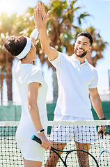 Image showing Tennis, friends and high five for sports game, exercise or workout together on the tennis court. Man and woman tennis player touch hands with smile in sport fitness for fun friendly match outdoors