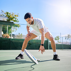 Image showing Tennis, sports and knee pain on court after training, match or game outdoors. Healthcare, male athlete or tennis player drop racket with leg injury, inflammation or joint pain after exercise accident