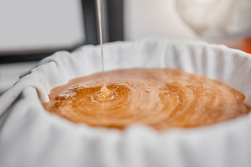 Image showing Honey, pour and production in a factory on a farm for sweet, natural and organic honeycomb. Sustainable, agriculture and industry beekeeping farming processing a raw liquid product in a warehouse.