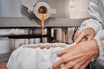 Image showing Honey, hands and storage machine, product and manufacturing in warehouse, beekeeper workshop or factory. Person pouring, industry and production in agriculture farming, gold liquid and sustainability