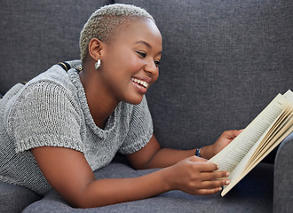 Image showing Book, relax and black woman reading on a sofa for knowledge in the living room of her house. Happy, smile and African girl enjoying a fantasy story or novel while relaxing on the couch at her home.