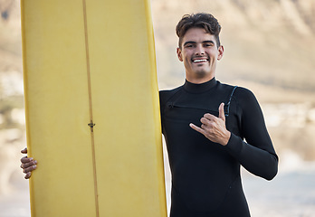 Image showing Happy surfer, hand sign and man, portrait and motivation, beach and summer sports, freedom and happiness in sunshine. Surfing board, shaka and smile guy, ocean and relax, adventure and Miami vacation