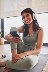 Image showing Yoga, headphones and smartphone woman with fitness music for wellness, motivation and body goals in happy portrait. Pilates, training and cardio Indian girl using phone and listening to an audio app