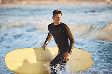 Image showing Surfing, water sports and surfer man at beach for fitness, wave and adventure during summer travel in Australia. Happy man in sea with surfboard for freedom, training and professional sport