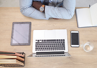 Image showing Laptop, tablet and phone with a business man sitting at his desk in the office at work from above. Flatlay, computer and technology with a male employee working on a table or wooden surface