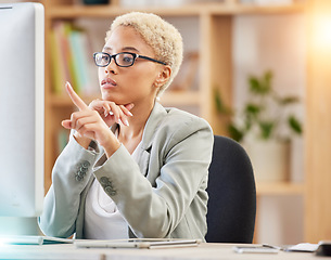 Image showing Black woman, computer and office desk while pointing at screen for accounting, finance and analysis on web. Woman, pc and focus research, technology and reading documents, report or analytics at job