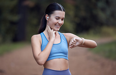 Image showing Fitness, runner and woman checking watch for pulse, time or heart rate after running exercise or workout in nature. Athletic female monitoring physical wellness or training performance on smart watch