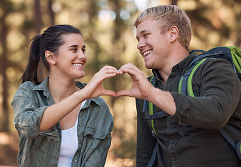 Image showing Love, couple and heart hands while hiking in nature for affection or support. Emoji, hand gesture and romance or intimacy shape with happy man and woman on adventure or trekking outdoors in forest.