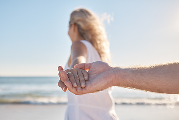 Image showing Holding hands, support and couple walking by beach for love, trust and quality time in marriage. Travel, tropical and man and woman on a walk by the sea to relax on holiday by the water in Bali