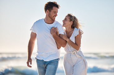 Image showing Holding hands, love and couple walking on beach during travel, freedom and quality time for support on holiday. Care, smile and man and woman on a vacation for marriage, relax and happy by the sea