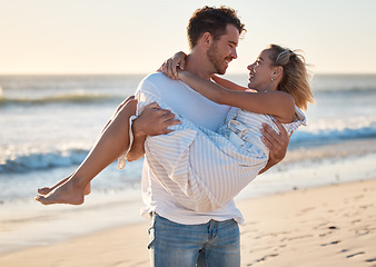 Image showing Couple, beach and man carrying woman for love, relax and marriage support together on travel adventure or vacation. Freedom, trust and happy man at Hawaii ocean outdoor for quality time in sunshine