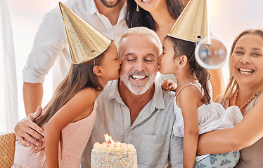 Image showing Family, birthday and girls kiss grandfather at home in celebration. Big family, cake and kids kissing grandpa with grandma, mother and father celebrating, having fun and enjoying party time together.
