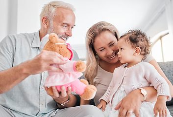 Image showing Toy, grandparents and baby play, happy and smile together in family home. Family, teddy bear and senior people with girl kid, development and child bonding with happiness, love and care in house