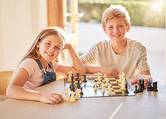 Image showing Portrait, chess and children relax at a table with board game, bond and learning in a living room in their home. Kids, chessboard and brain activity by girl and boy playing, planning and thinking